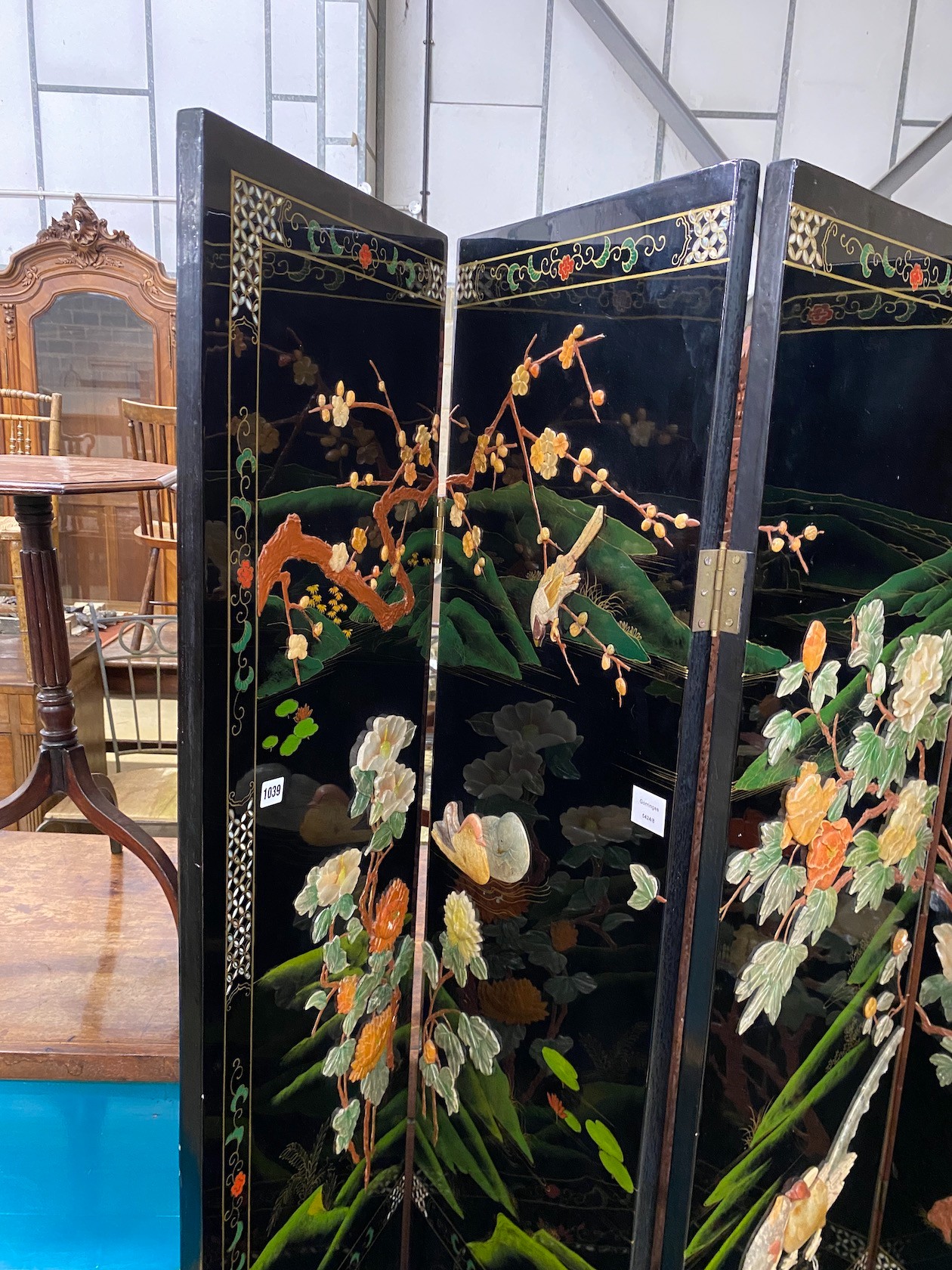 A Chinese black lacquer four fold dressing screen, each panel width 40cm, height 185cm